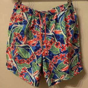 Men’s Vineyard Vines Swim Trunks, blue with green leaves and red pink flowers.